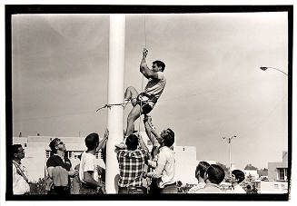 Untitled (Pro-war Protestor Climbing Flagpole to Remove Strike Flag)