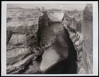 Glen Canyon Dam, Arizona, view from downstream toward the dam, with canoeist and sandbar (from the Remnants of the First World series)