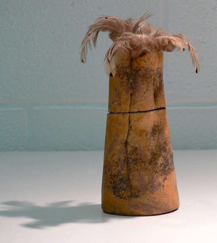 Untitled (clay vessel with feathers)