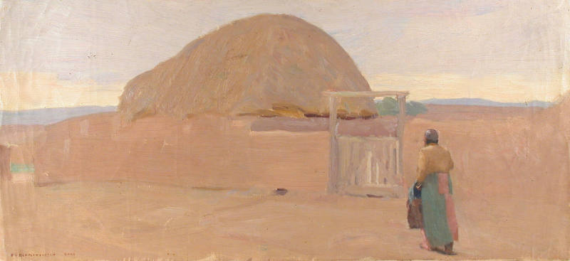 Untitled (Indian woman in green dress before adobe wall)