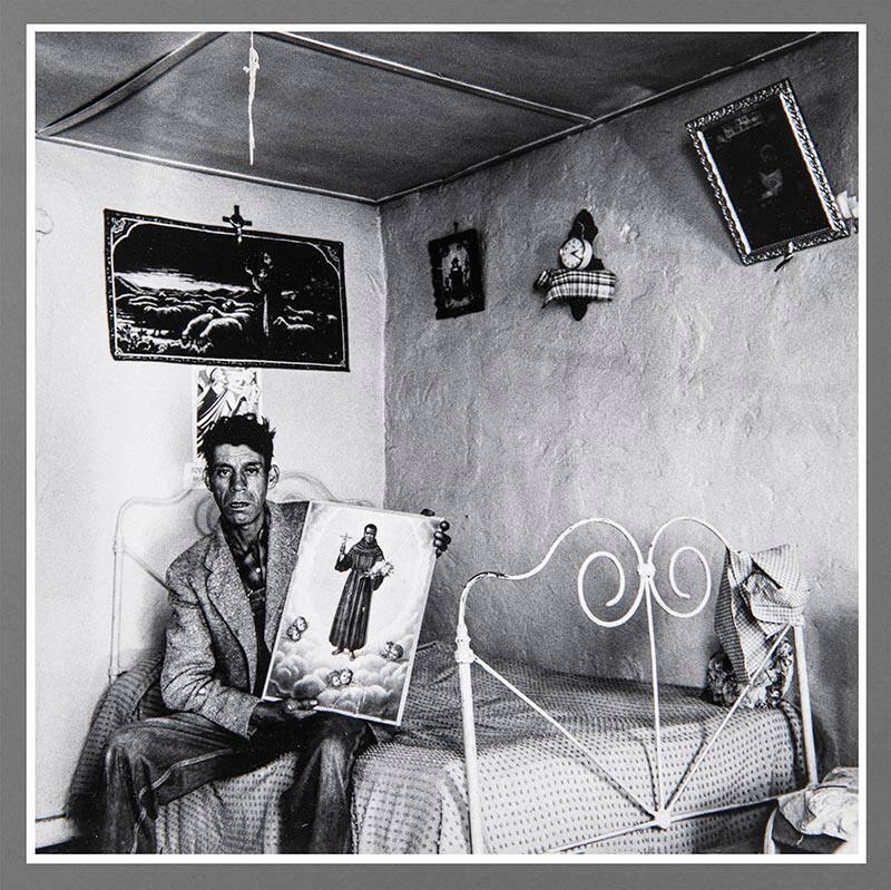 Untitled (Man on bed holding picture)