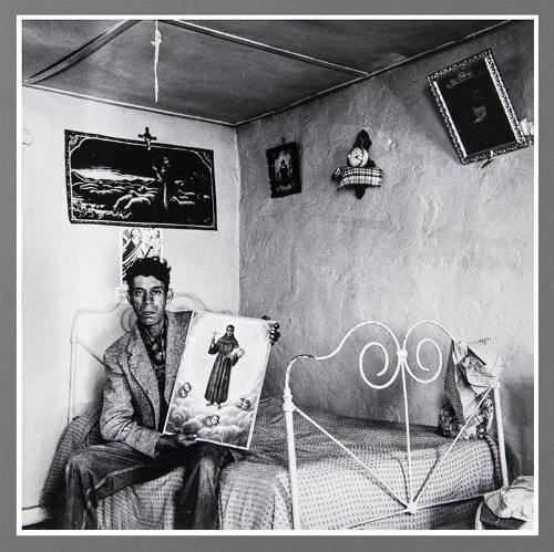 Untitled (Man on bed holding picture)