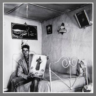 Untitled (Man on bed holding picture)