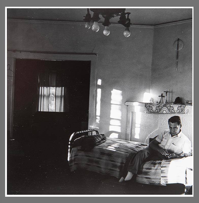 Untitled (Man seated on twin bed)
