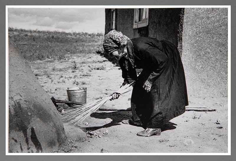 Taos Vicinity: Sweeping Coals from Outdoors Oven