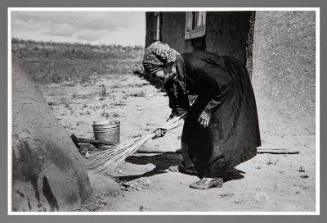 Taos Vicinity: Sweeping Coals from Outdoors Oven