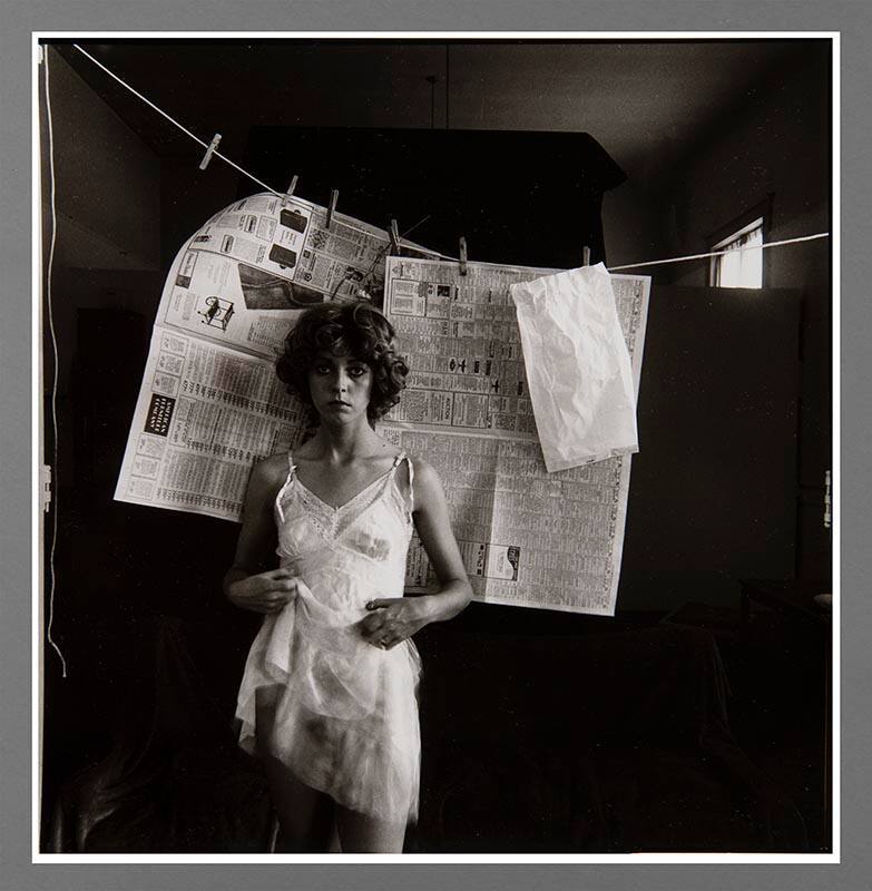 Untitled (Woman in slip with newspaper)