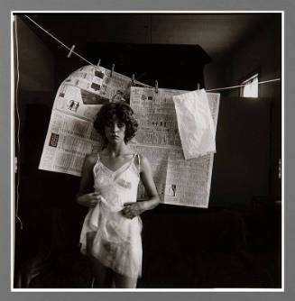 Untitled (Woman in slip with newspaper)