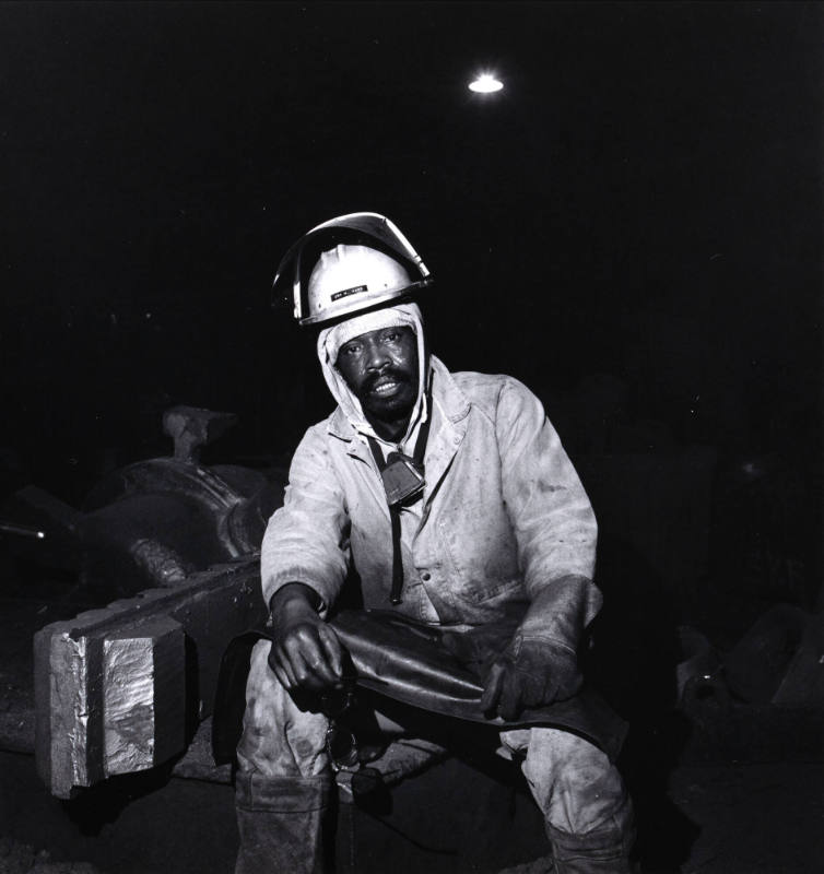 Untitled (Seated man in hardhat)