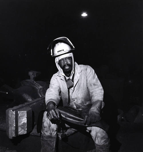Untitled (Seated man in hardhat)