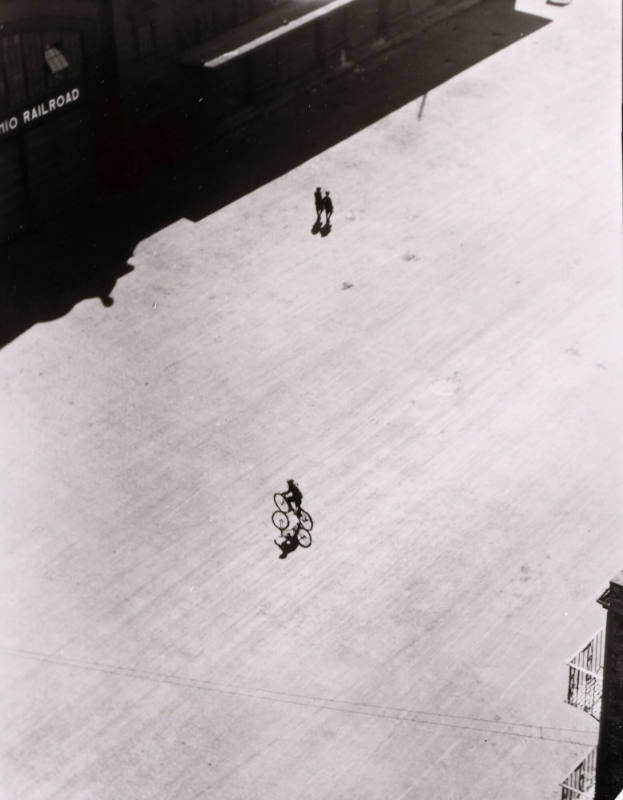 Boy on Bike Below Brooklyn Bridge