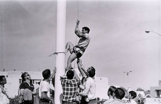 Untitled (Pro-war Protestor Climbing Flagpole to Remove Strike Flag)