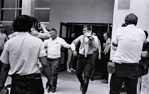 Untitled (Trainer Leads Injured Athlete From Building)