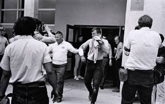 Untitled (Trainer Leads Injured Athlete From Building)